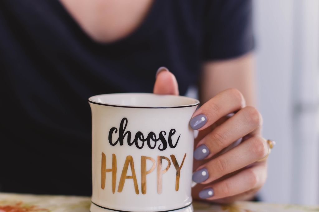 Woman with "Choose Happy" mug.